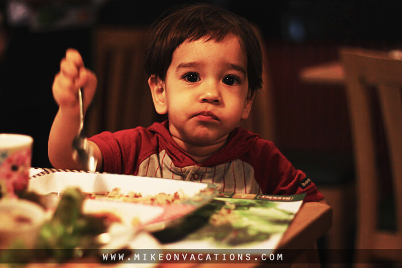 Toddler eating from a children's menu in a family-friendly cafe in Pattaya, Thailand
